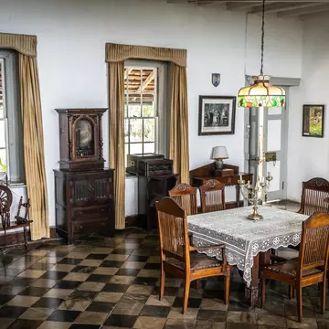 Montego Bay, Jamaica - June 06 2015: Greenwood Great House Antique Museum. Vintage furniture in dining room area inside antique mansion in the Caribbean. Checkered flooring, 6 seat table, chandelier.; Shutterstock ID 1122712505;