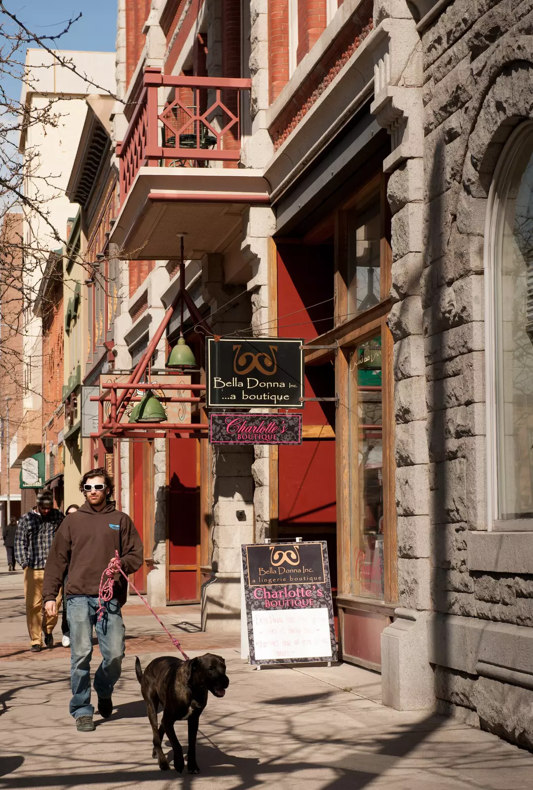 A man walking a dog in Downtown Missoula