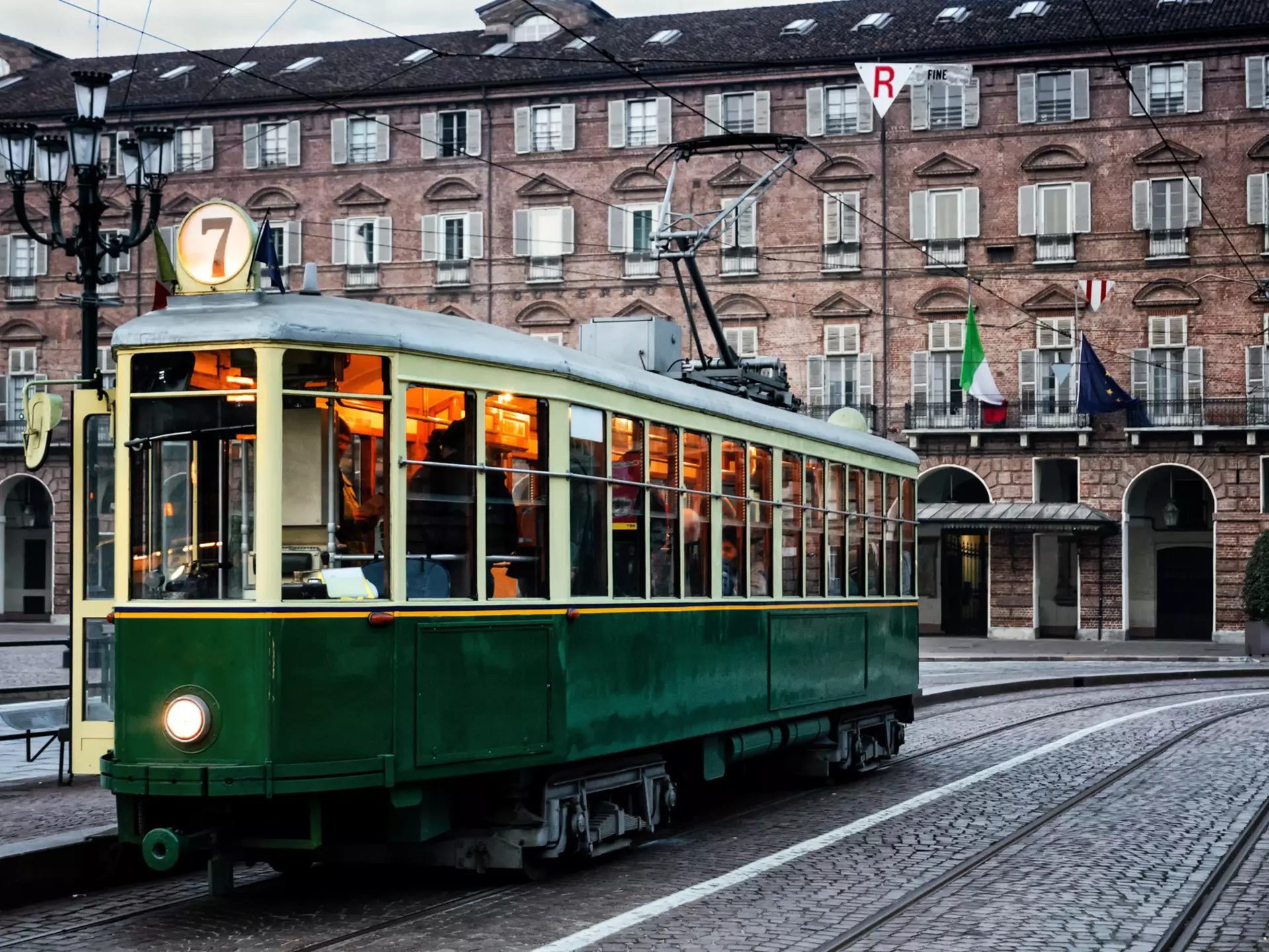 Turin's historic tram outside a brick building