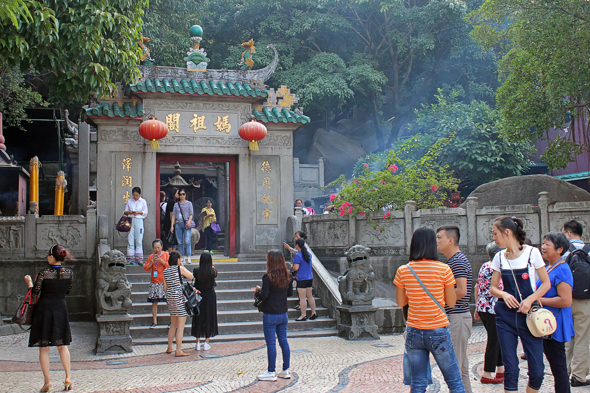 Visitors taking selfies and chatting with each other in front of A-Ma Temple