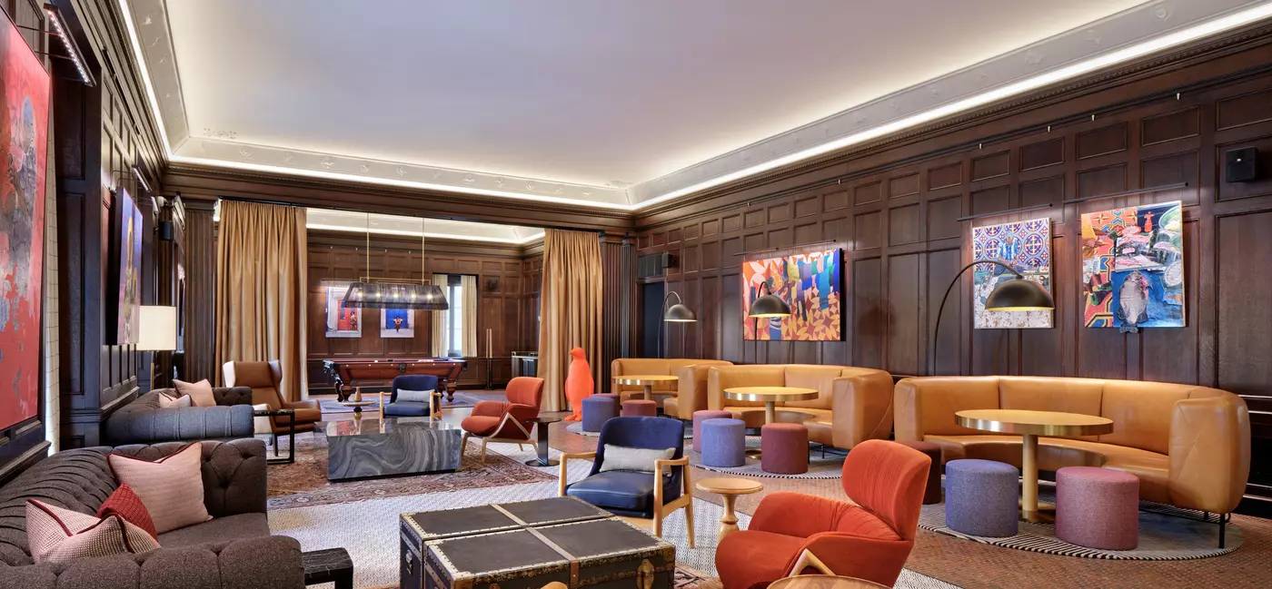 The billiards room 21c Museum Hotel in St Louis, with semicircle sofas and an array of eclectic furnishings