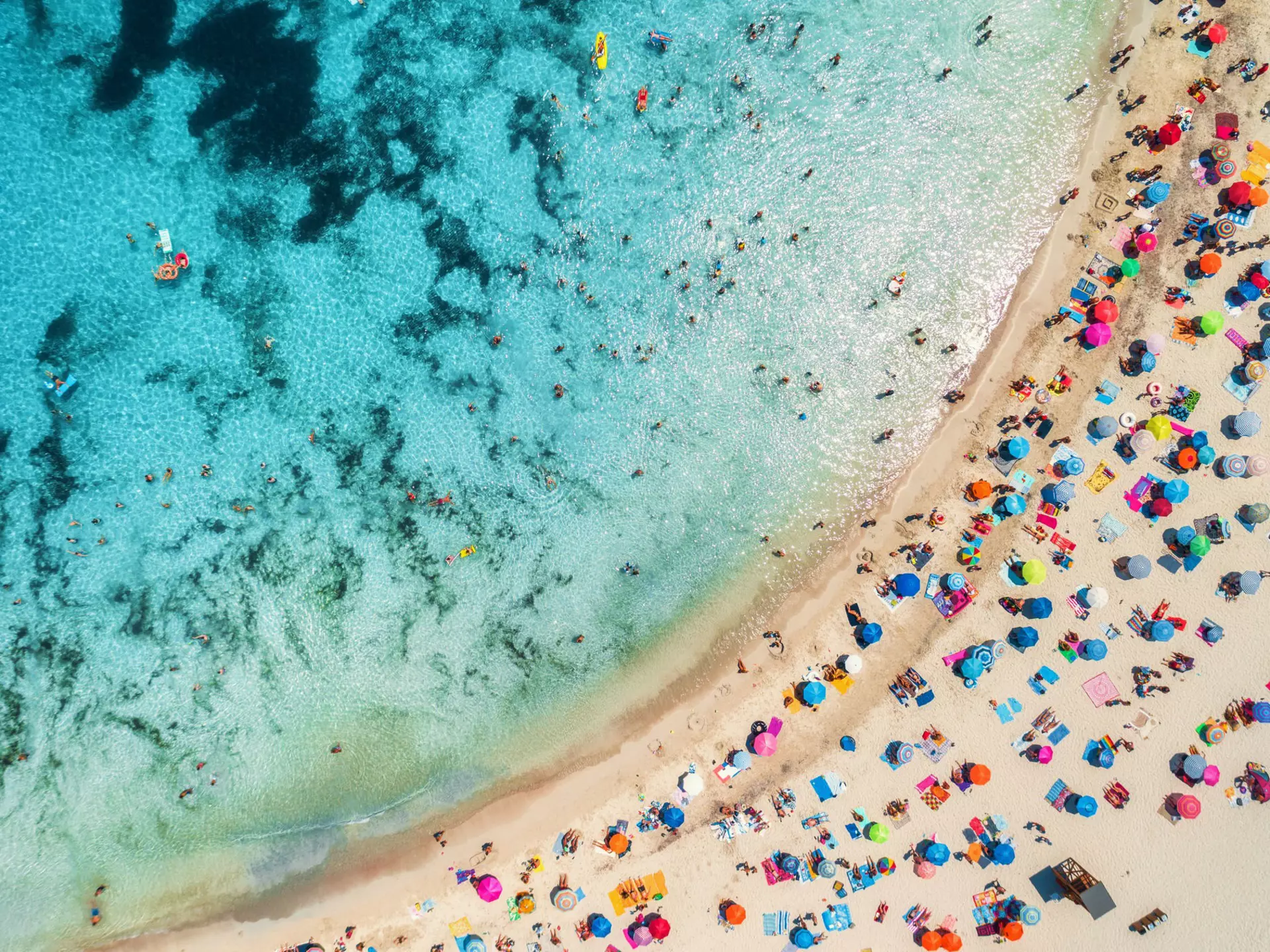Aerial of a crowded sandy beach with colourful umbrellas, sun bathers and swimmers during summer.
1139897468
above, aerial, background, bay, beach, beautiful, blue, coast, coastline, colorful, day, drone, europe, exotic, holidays, island, journey, lagoon, landscape, leisure, lie, marina, nature, ocean, paradise, people, relax, resort, sand, sandy, sea, seascape, seashore, shore, spain, summer, sunny, swim, top, transparent, travel, tropical, vacation, view, water, wave, parasol, umbrella