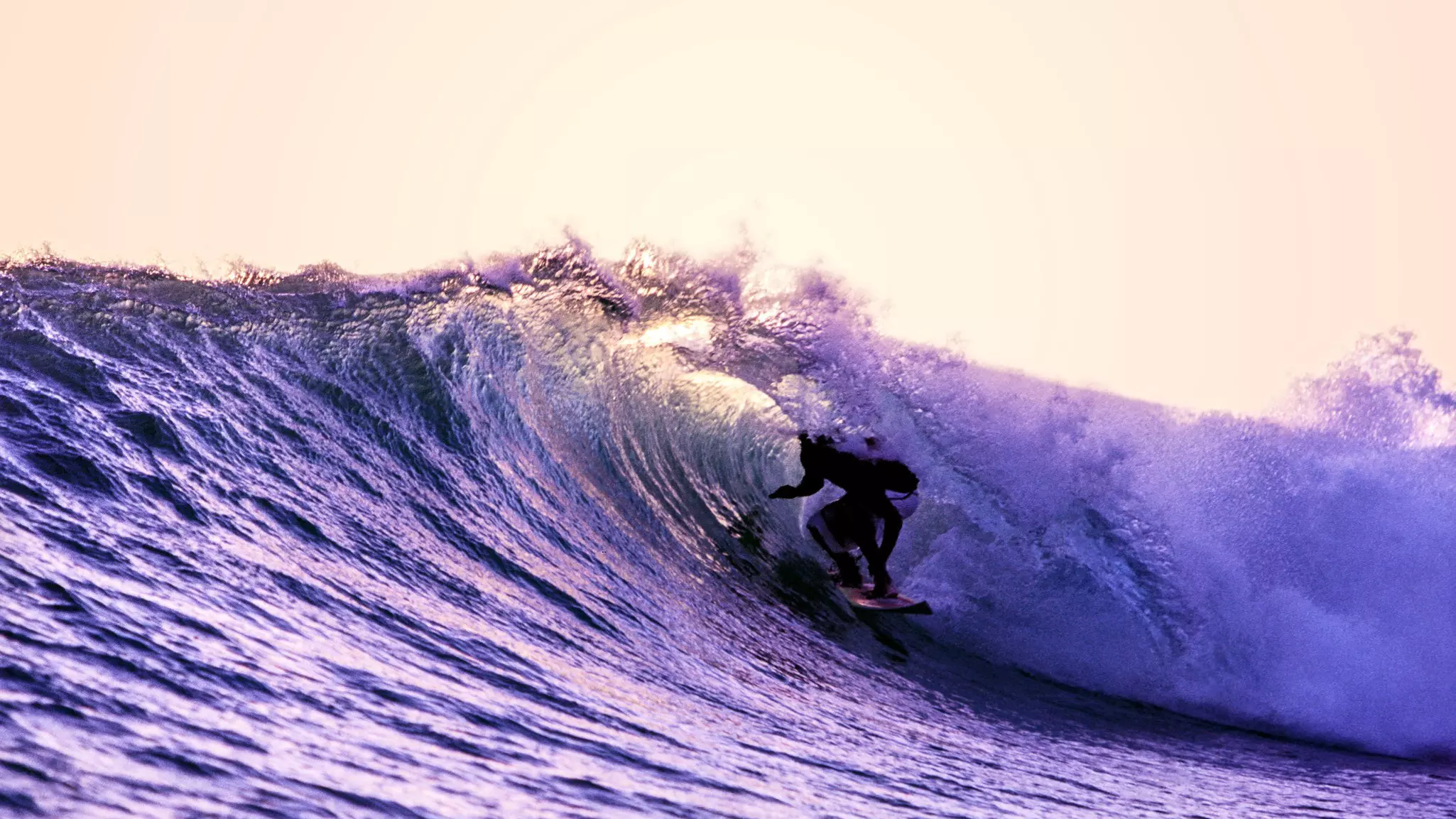 A surfer on the waves of the Savu Sea, East Nusa Tenggara, Indonesia
