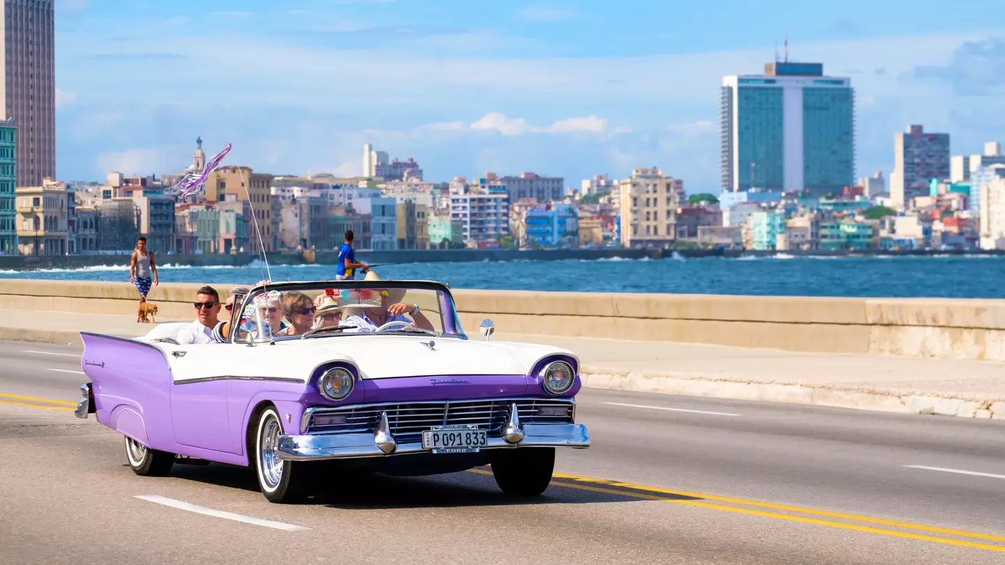 A classic car on the seafront in Havana