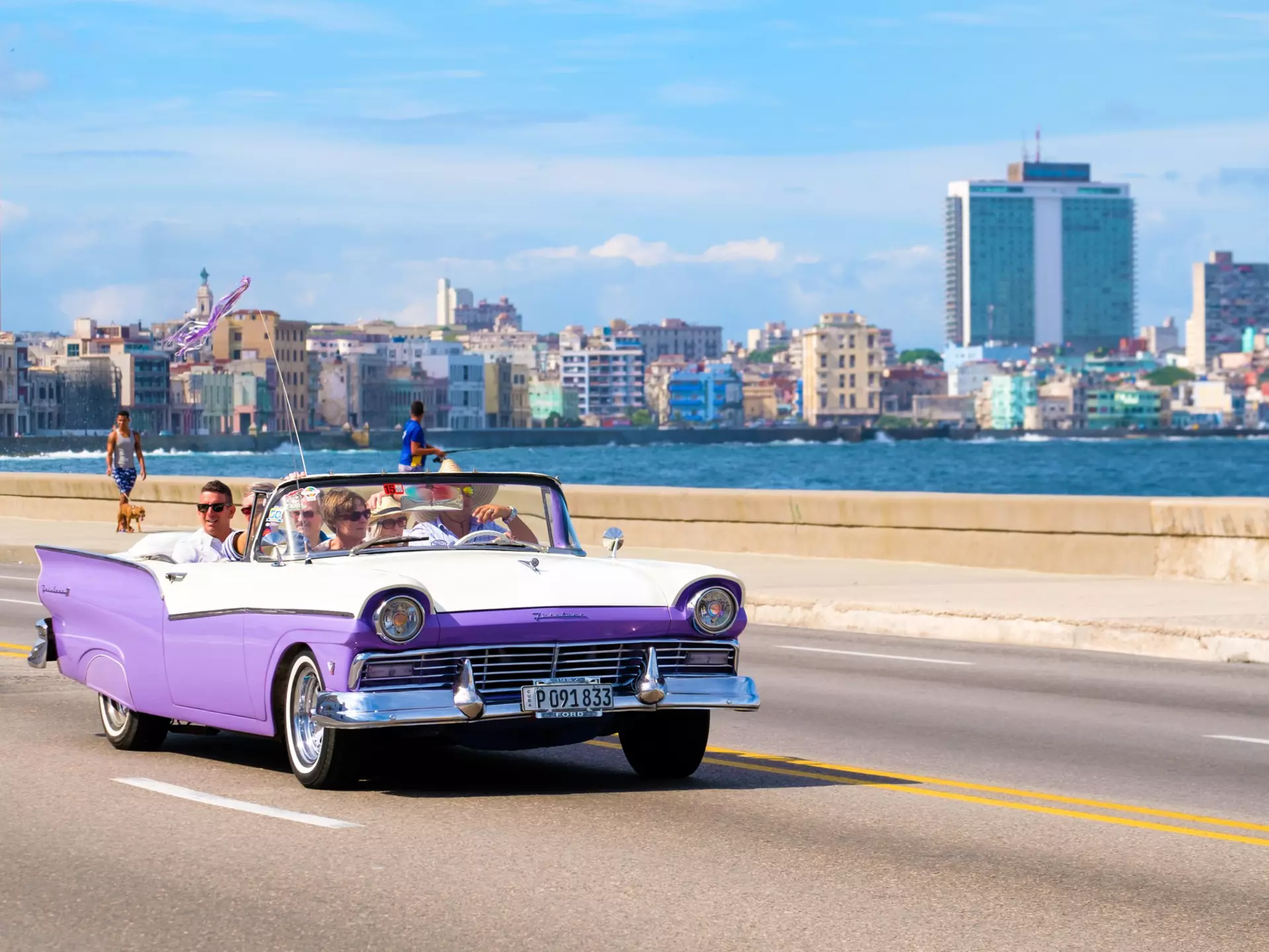 A classic car on the seafront in Havana