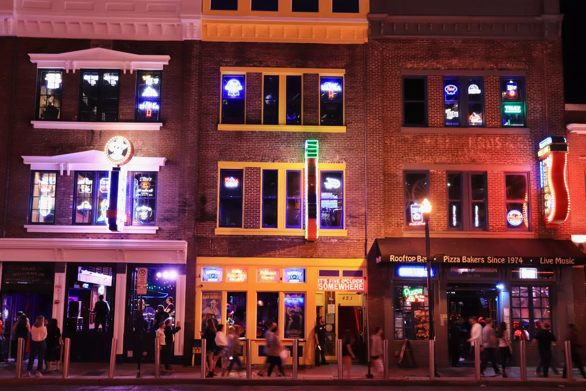 Famous Lower Broadway Avenue Neon signs. Blues, rock and country music clubs illuminated at night in downtown. This a main Nashville city attraction