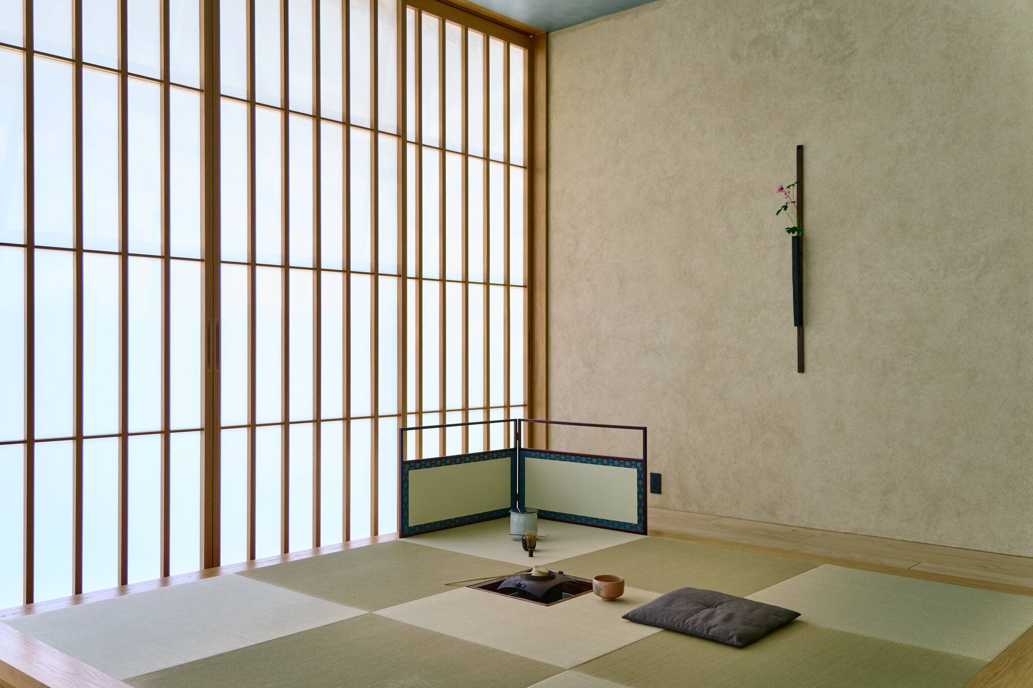 A simple, traditional room with an opaque wall with many panes at a hotel in Tokyo