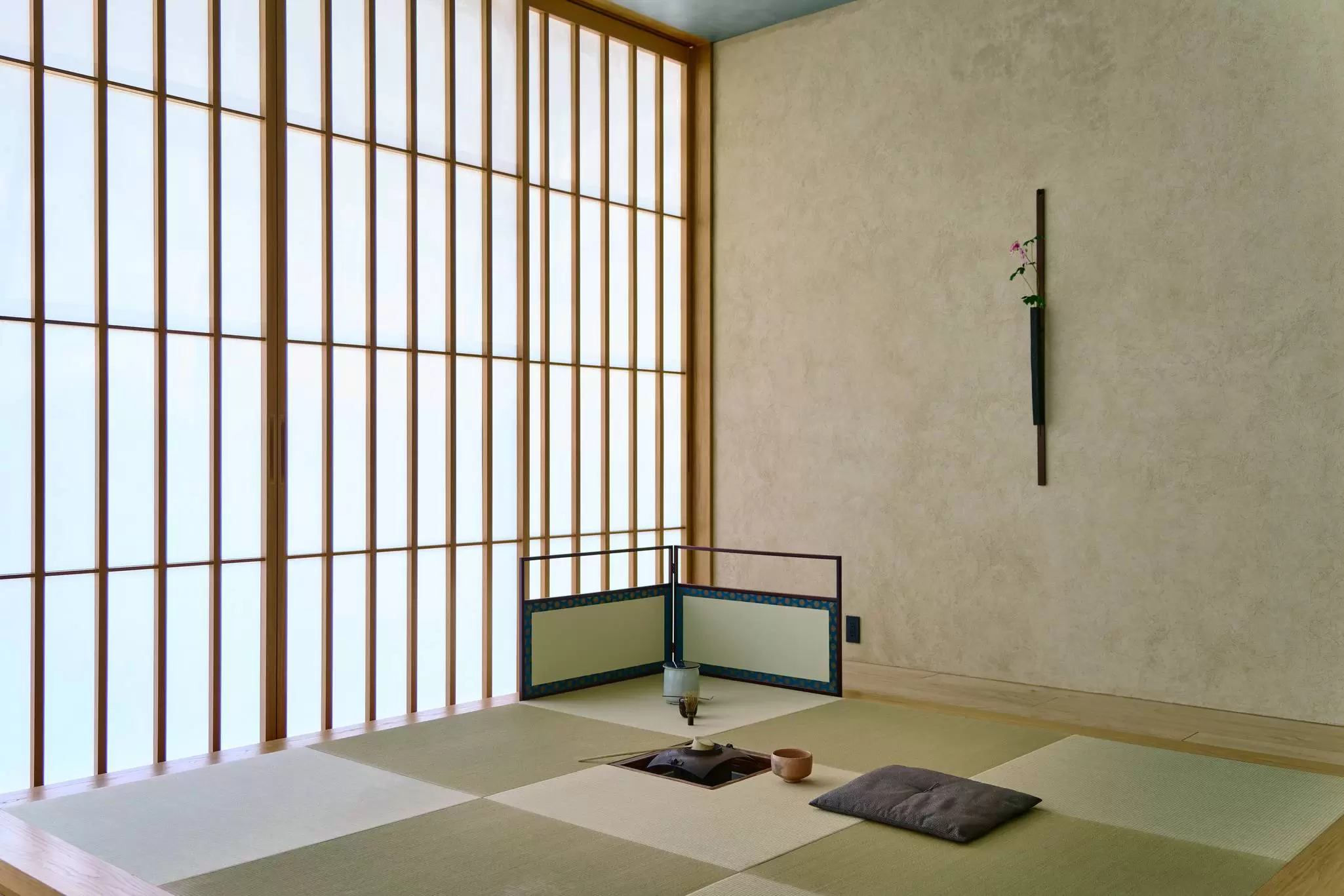 A simple, traditional room with an opaque wall with many panes at a hotel in Tokyo