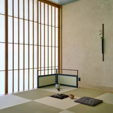 A simple, traditional room with an opaque wall with many panes at a hotel in Tokyo
