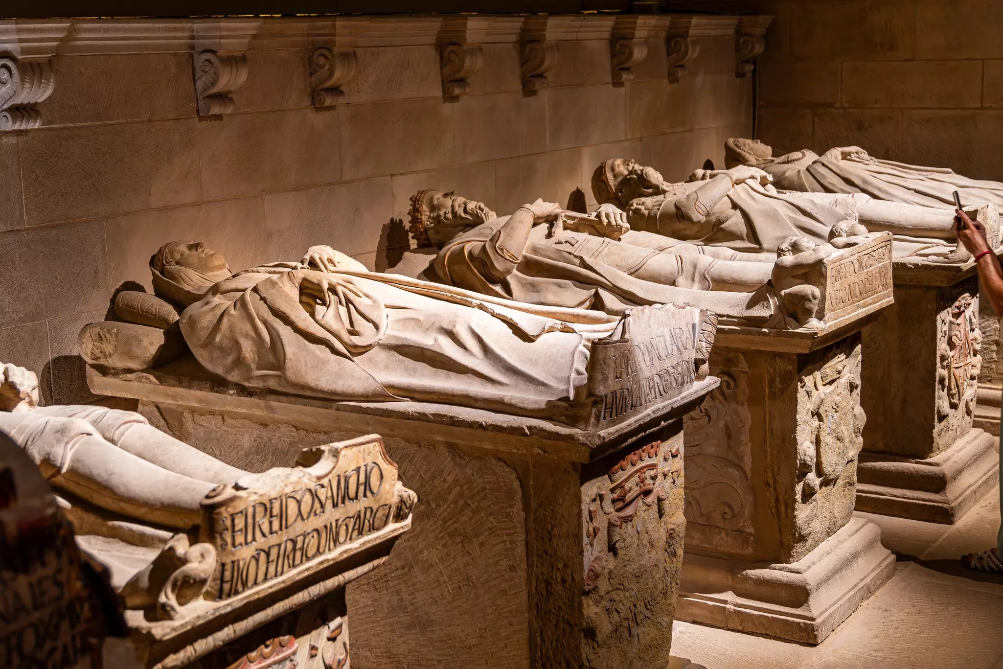 Tombs with marble statues of people lying on them in the Royal Pantheon of Santa María la Real inside the Catedral of Santa María.