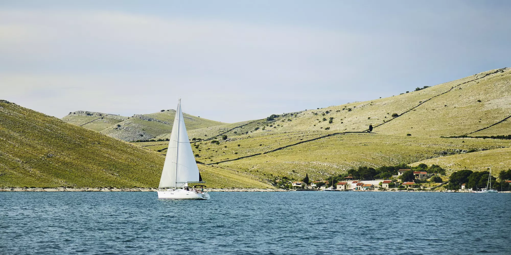 Yacht sailing in Kravljačica Bay on Kornat island.