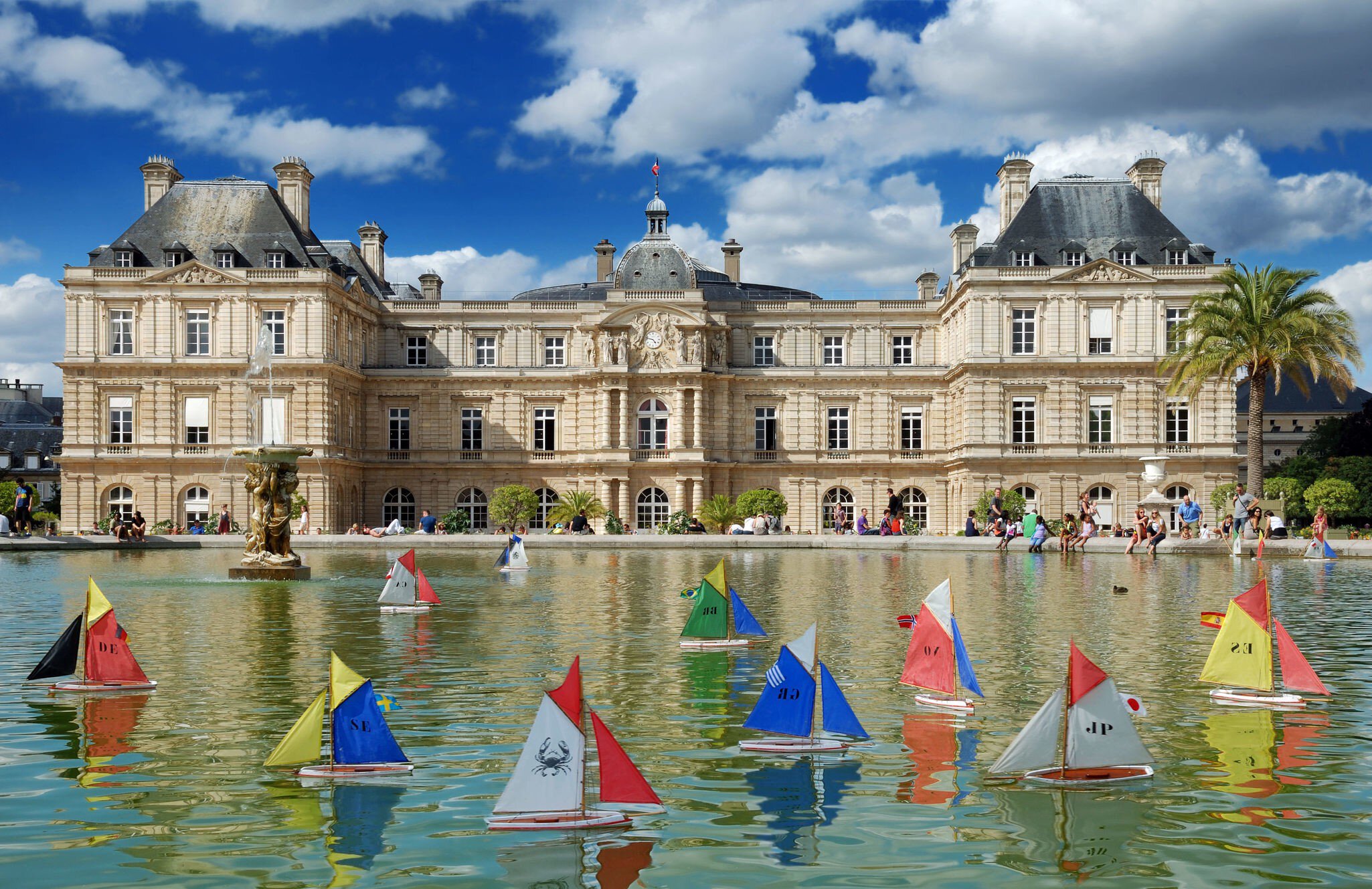 JULY 30, 2012: Model sailing boats in the pool in front of Luxembourg Palace in Luxembourg Gardens.