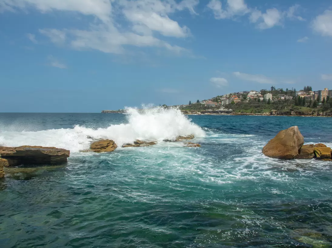 Waves crashing at Giles Baths from Dolphin Point at the northern end of the Coogee Beach on Thompsons Bay near Sydney, New South Wales, Australia.