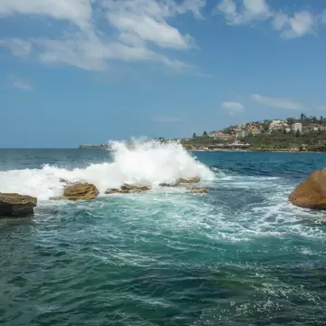Waves crashing at Giles Baths from Dolphin Point at the northern end of the Coogee Beach on Thompsons Bay near Sydney, New South Wales, Australia.