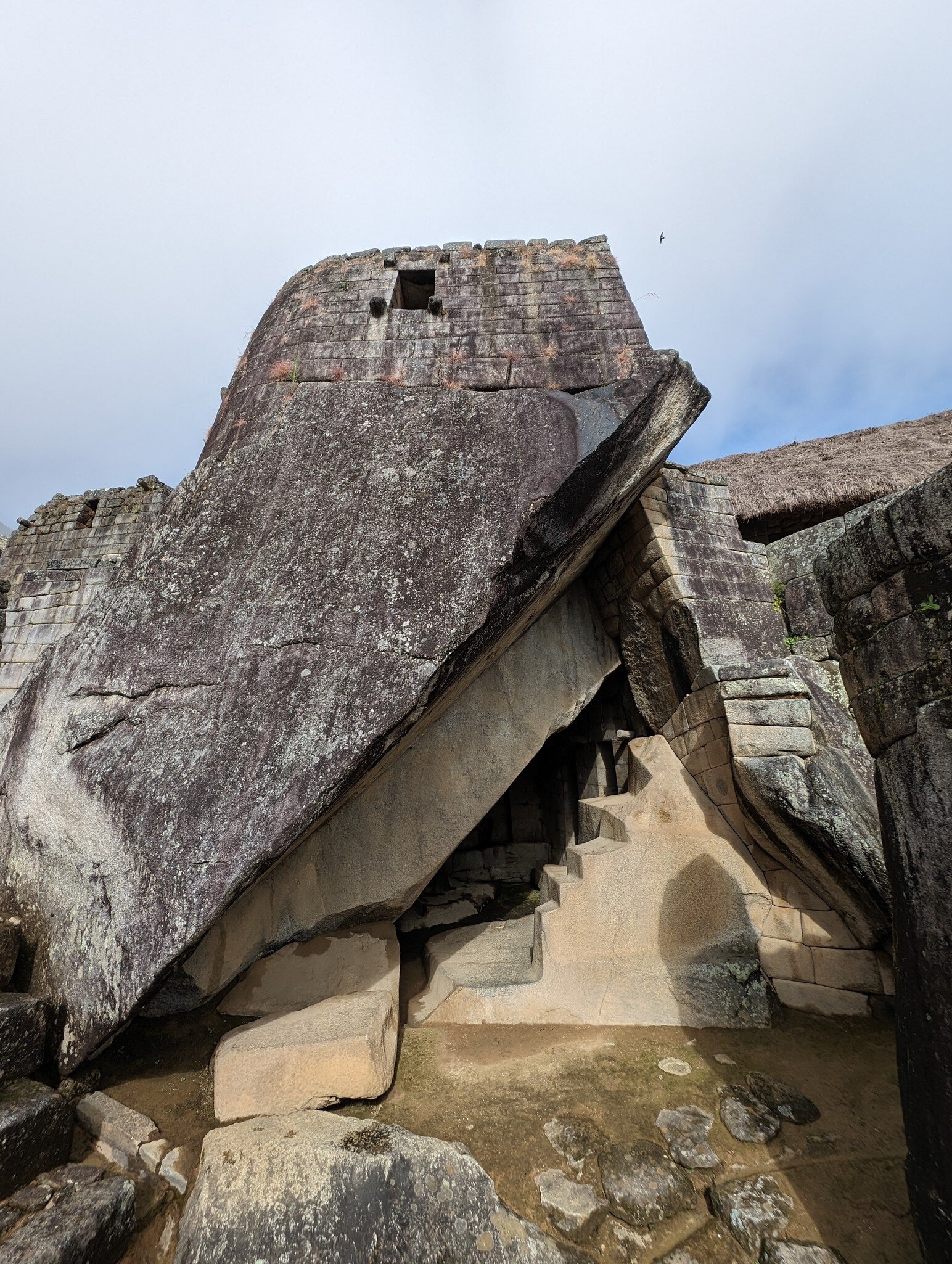 The triangular opening of the Royal Tomb located below the Temple of the Sun in Machu Picchu, Peru.