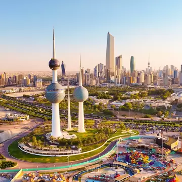 Aerial view of the Kuwait Towers on the waterfront with the Kuwait City skyline and Liberation Tower beyond