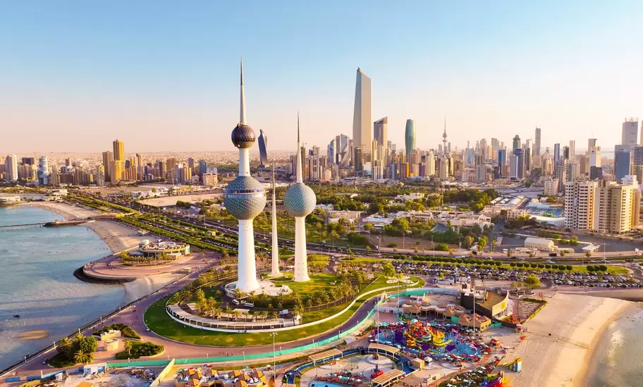 Aerial view of the Kuwait Towers on the waterfront with the Kuwait City skyline and Liberation Tower beyond