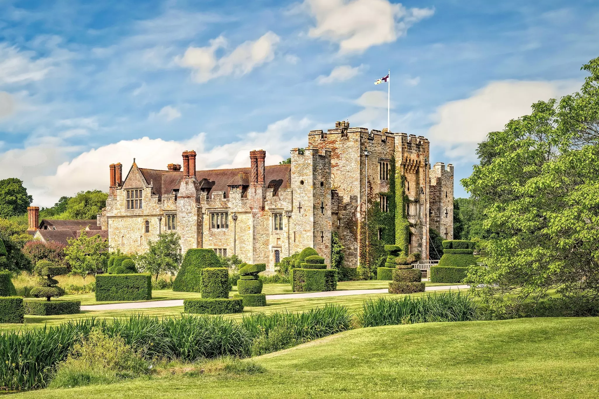 A large Tudor fortress set in landscaped gardens.