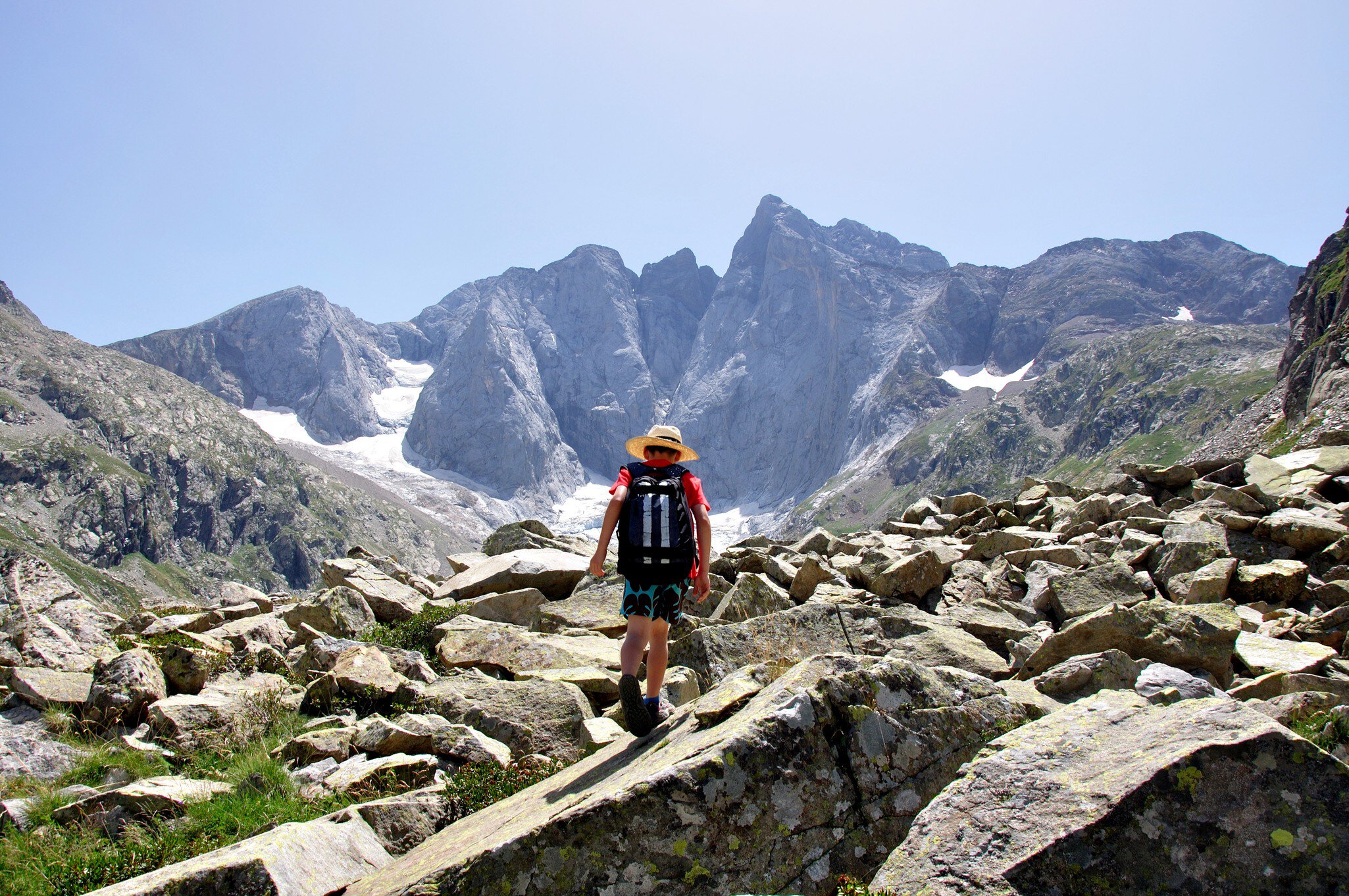 Kid hiking in Pyrenees near Vignemale peak.