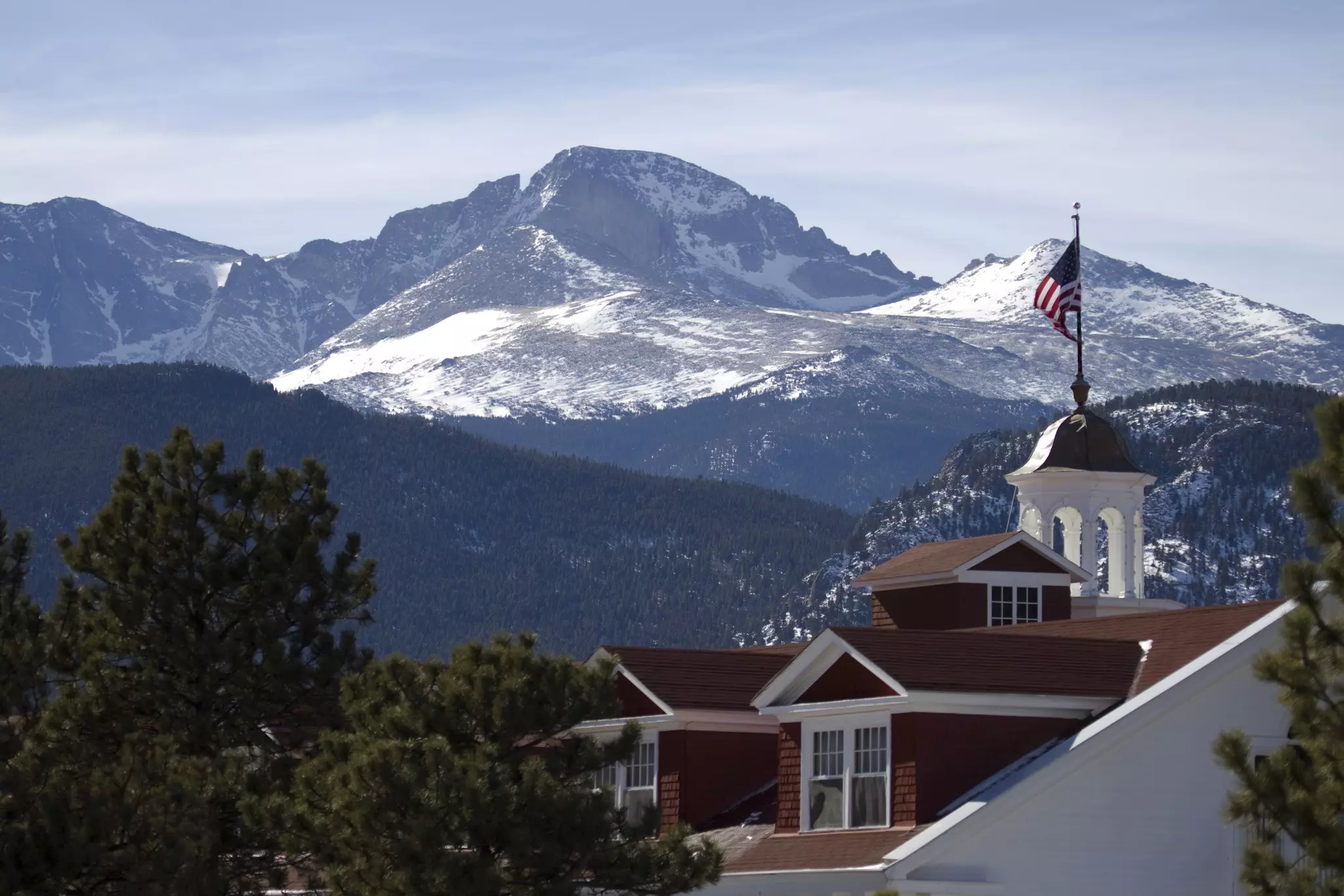 Longs Peak (14,255 feet) towers over the historic 1907 Stanley Hotel in Estes Park.
182199963
Photography, Color Image, Outdoors, Deep Snow, History, Travel Destinations, Horizontal, Hotel, Flag, Estes Park, Winter, Snow, Mountain Range, Longs Peak, Rocky Mountains, Nature, Colorado, Mountain, Architecture And Buildings, Rocky Mountain National Park, No People