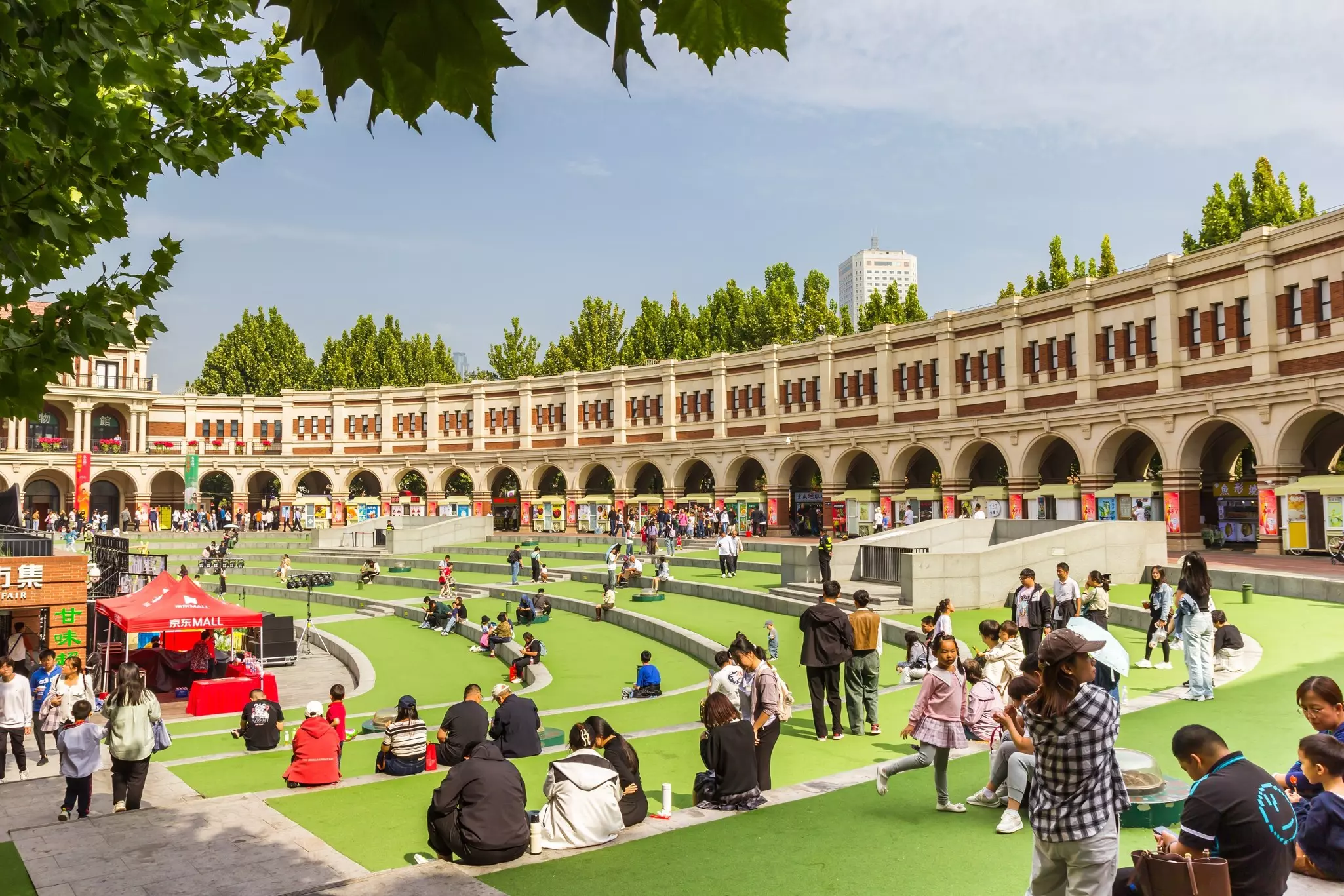 People sitting at the inner square of the Minyuan Stadium in Tianjin, China.