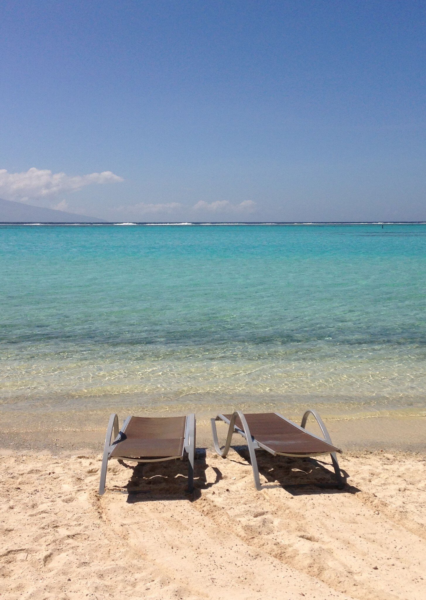 Two resort chairs on the beach by the lagoon in Temae Moorea, License Type: media, Download Time: 2025-05-29T18:46:07.000Z, User: lonelyplanetmedia, Editorial: false, purchase_order: 65050 - Digital Destinations and Articles, job: Global Publishing WIP, client: Global Publishing WIP, other: Peterson Haggarty // SS Comp Ingestion