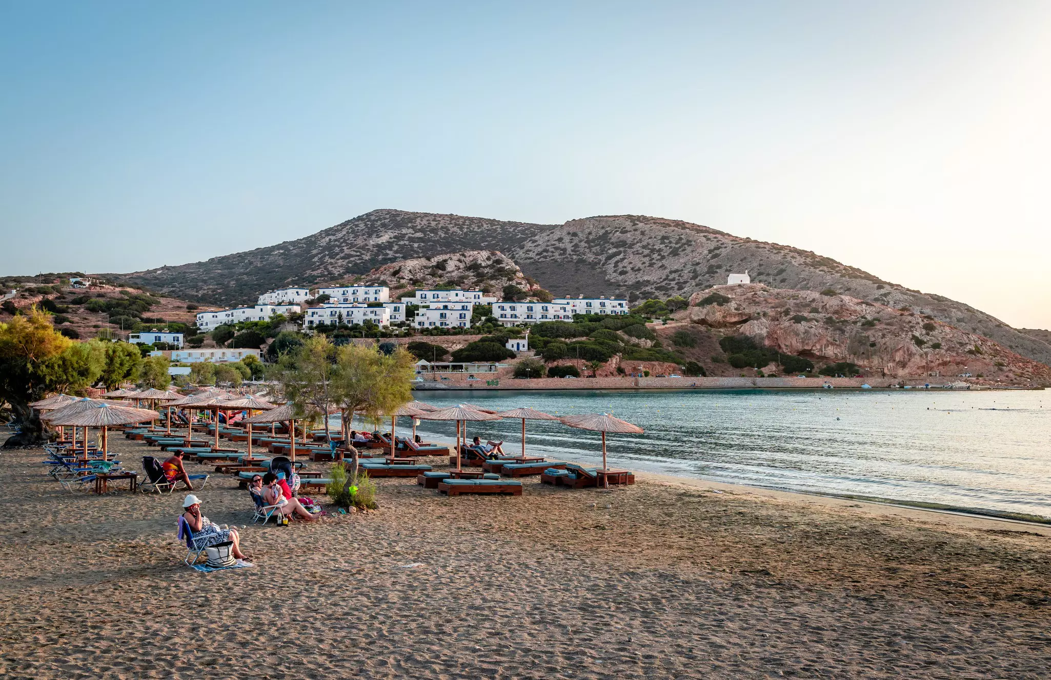 Swimmers enjoy the sunset at the beach at Galissas, Syros Island