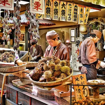Vendors prepare chestnuts to sell at Nishiki Market in Kyoto, Japan on 22 November 2016.