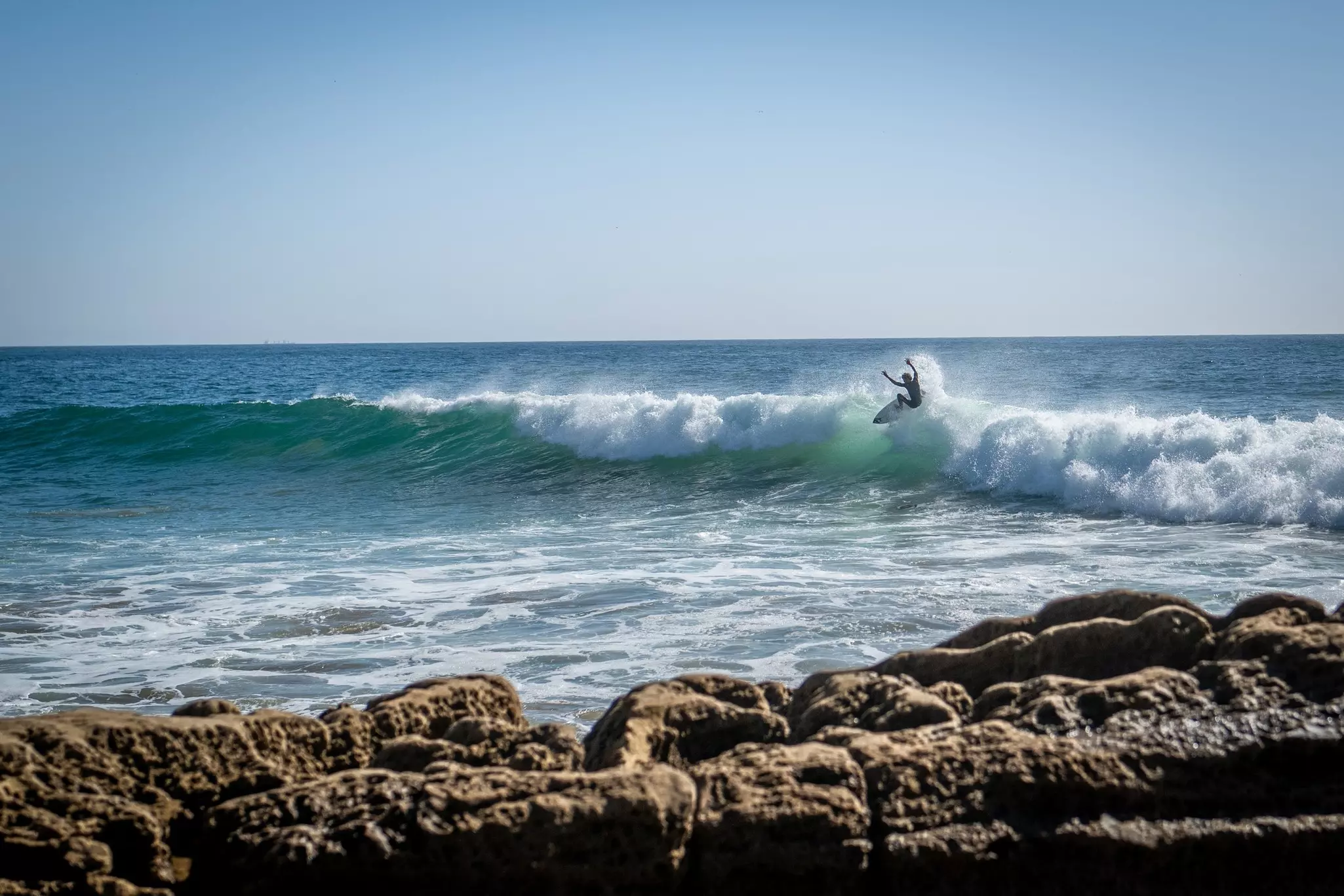 Surfer at anchor beach Taghazout Morocco