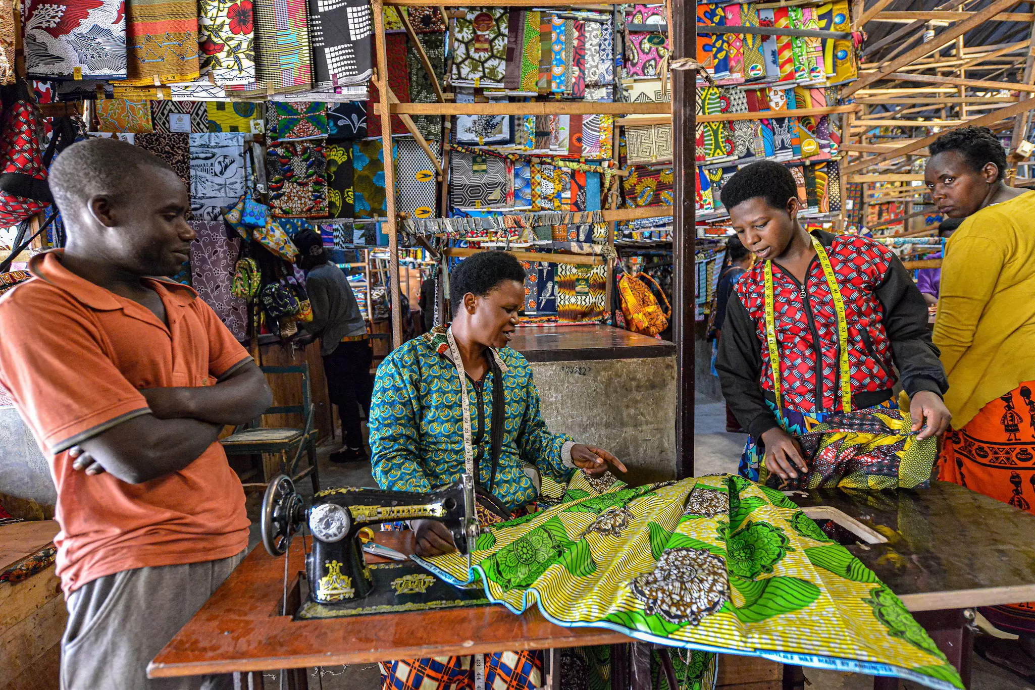 A seamstress making a dress in the Kimironko market in Kigali, Rwanda.  
