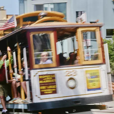 Blurred cable car trundles up a hill