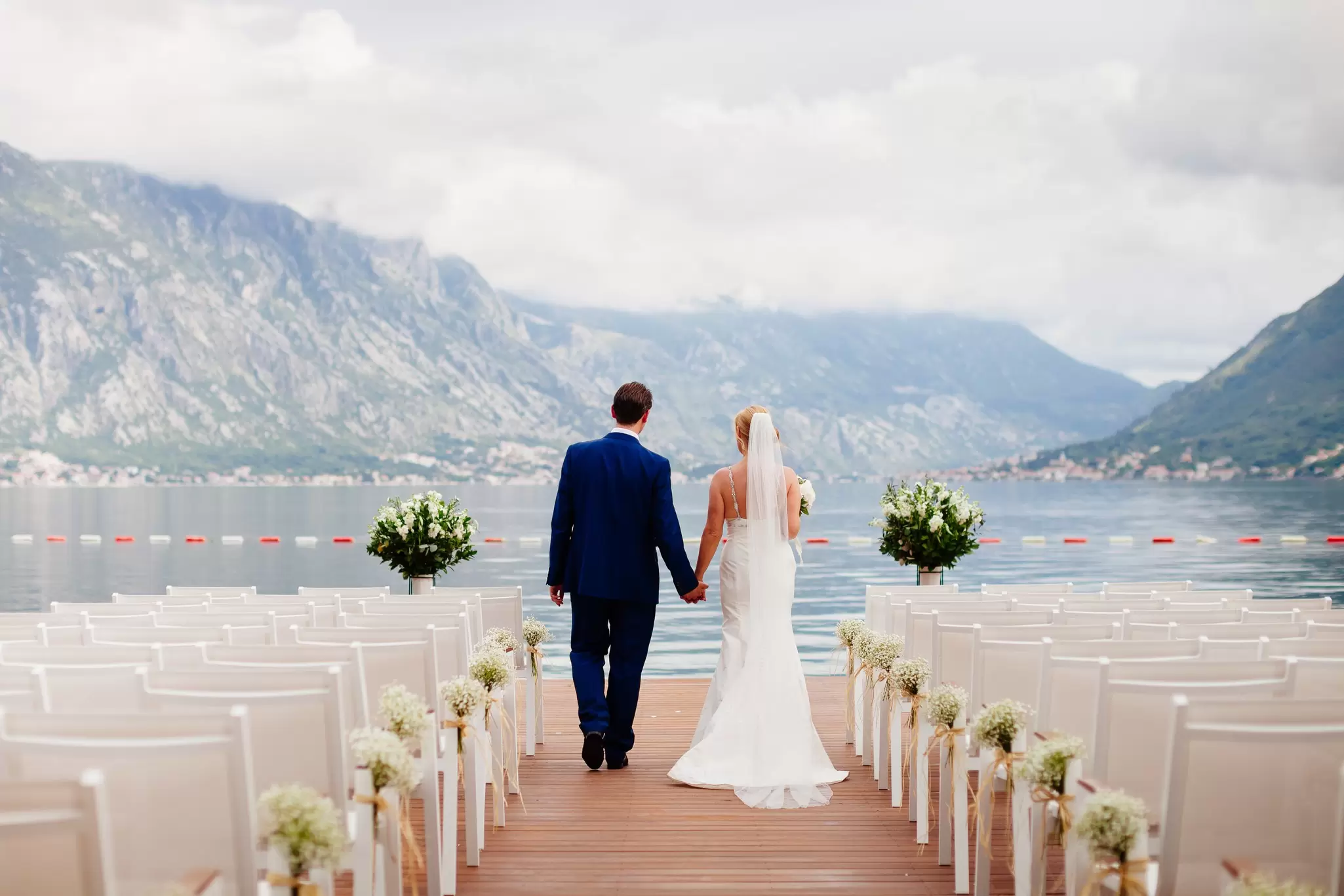 Destination weddings can seem like the ideal solution – but are they? LivingImages / Getty Images