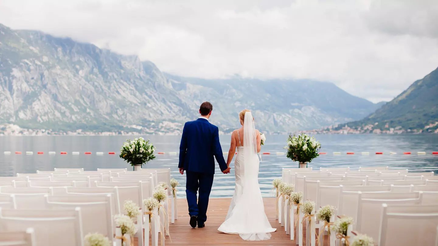 Destination weddings can seem like the ideal solution – but are they? LivingImages / Getty Images