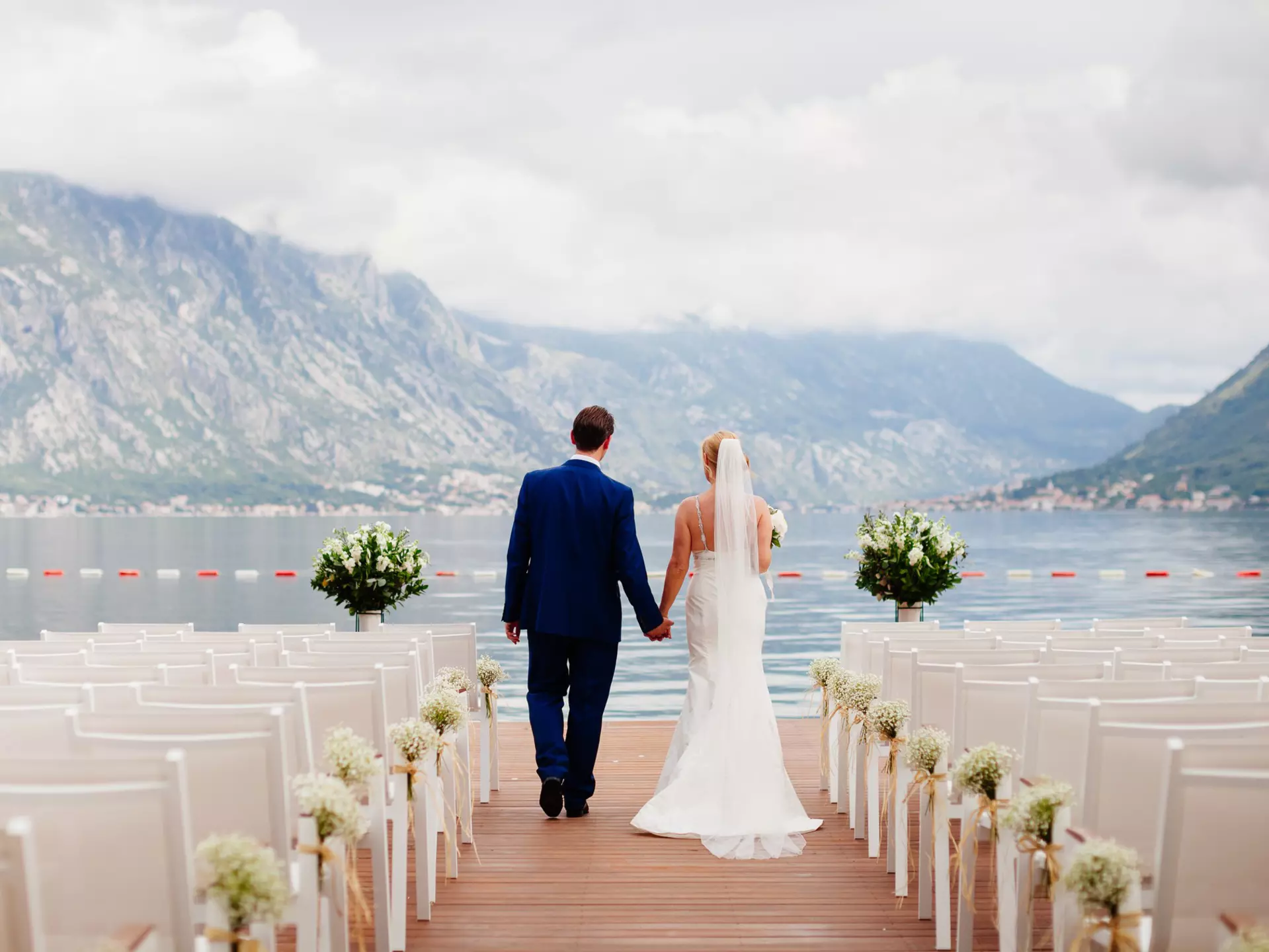 Destination weddings can seem like the ideal solution – but are they? LivingImages / Getty Images
