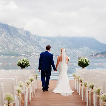 Destination weddings can seem like the ideal solution – but are they? LivingImages / Getty Images