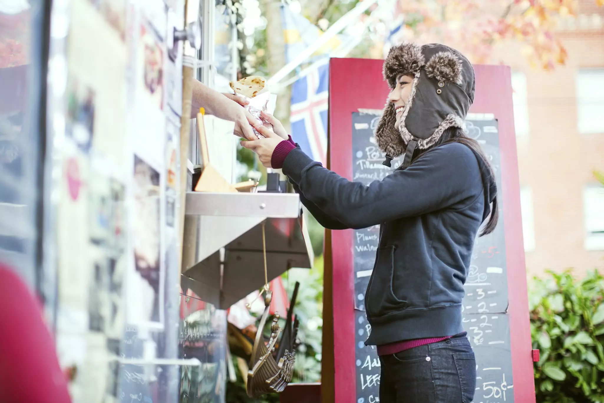 A beautiful young woman looks at a food cart pod in Portland, Oregon.