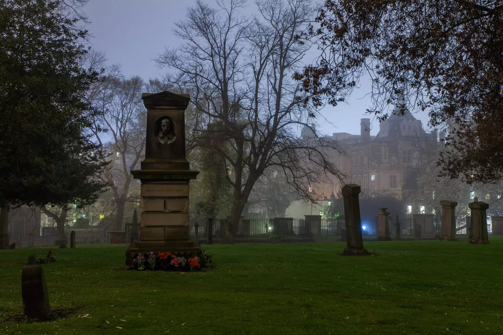 A graveyard shrouded in mist at night