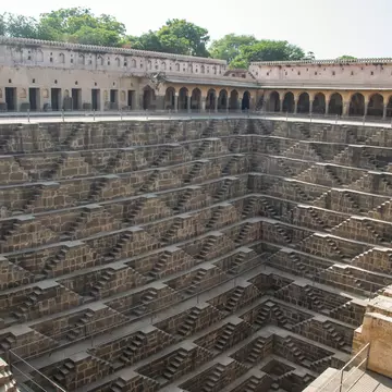 Chand Baori, a stepwell in the village of Abhaneri. Chand Baori consists of 3,500 narrow steps over 13 stories. It extends approximately 30 m (100 ft) into the ground.