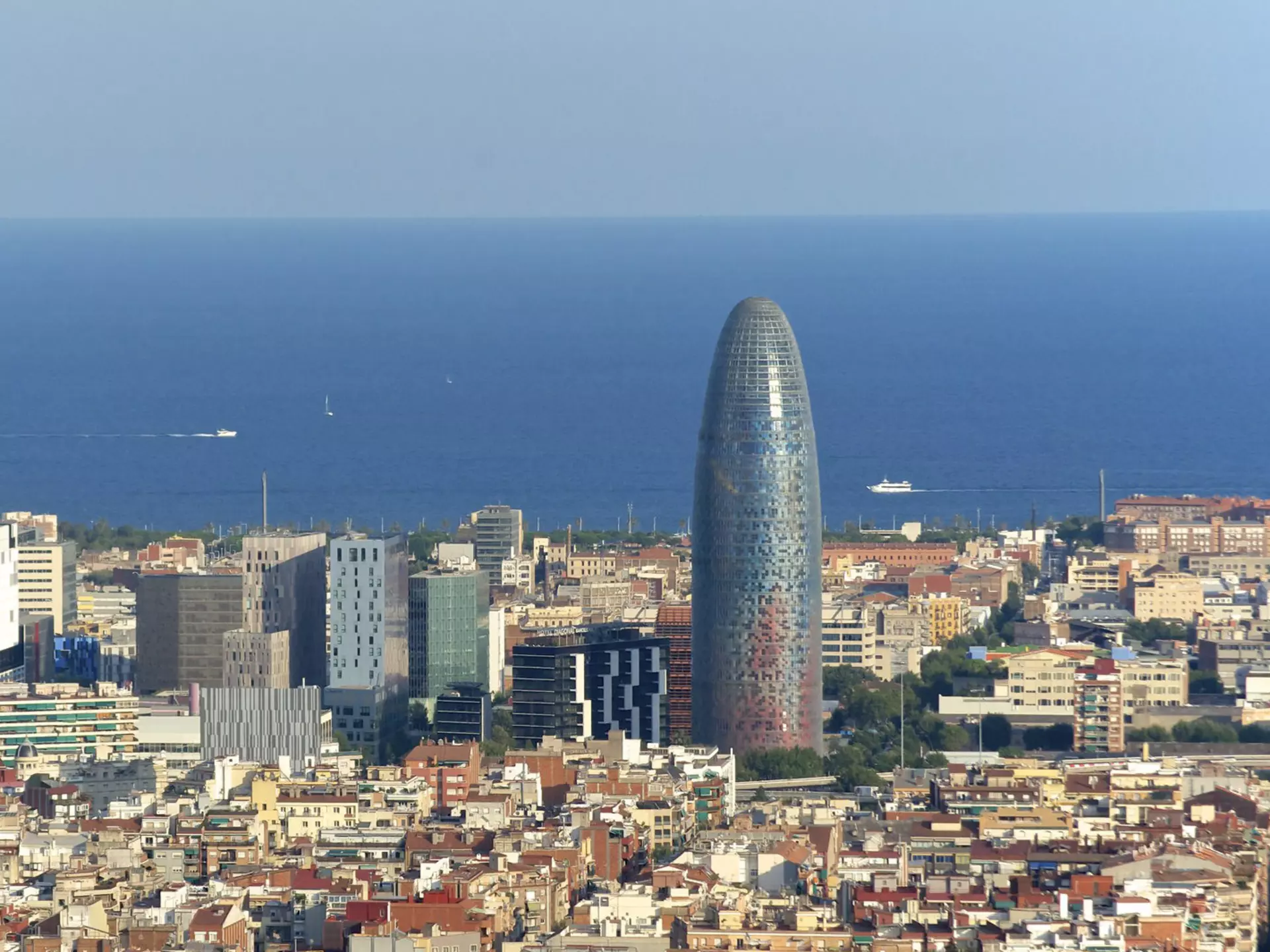 Looking over the skyline of Poblenou, with modern skyscrapers in the background and the blue Mediterranean beyond.