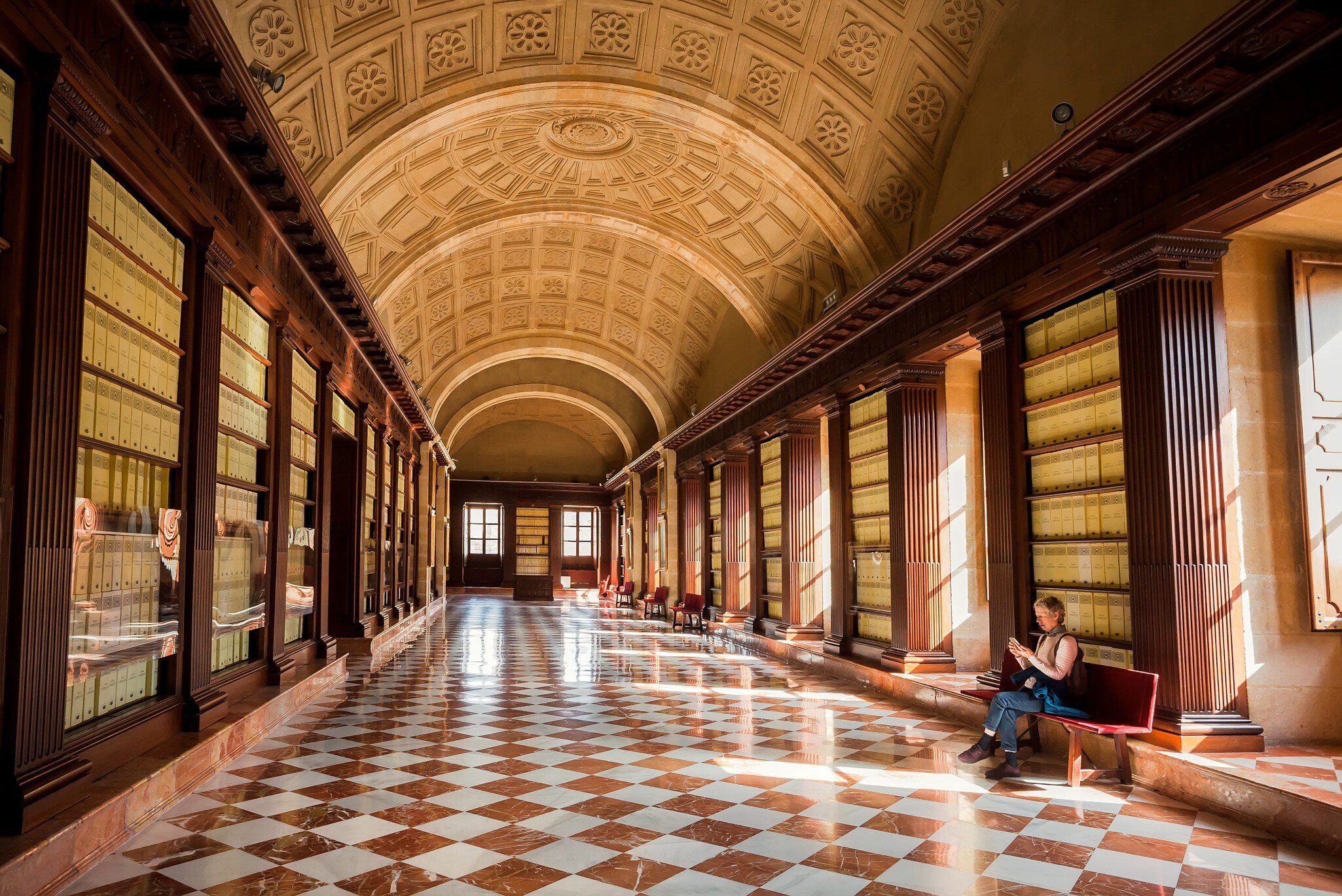 Lonely visitor of the 16th century Archivo General de Indias, example of Spanish Renaissance architecture on November 14, 2018. UNESCO World Heritage Site