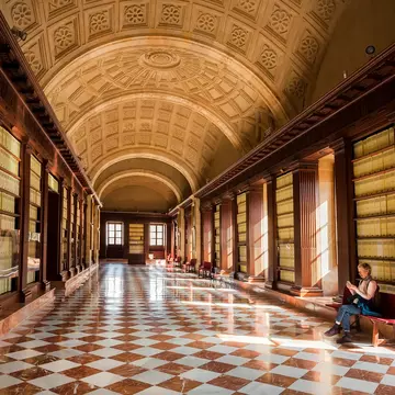 Lonely visitor of the 16th century Archivo General de Indias, example of Spanish Renaissance architecture on November 14, 2018. UNESCO World Heritage Site