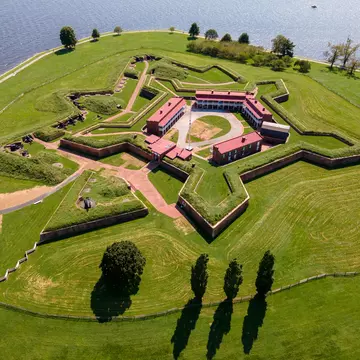 A star-shaped earthwork fort with green ramparts, seen from the air.