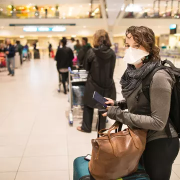 Woman in the airport wearing a mask.jpg