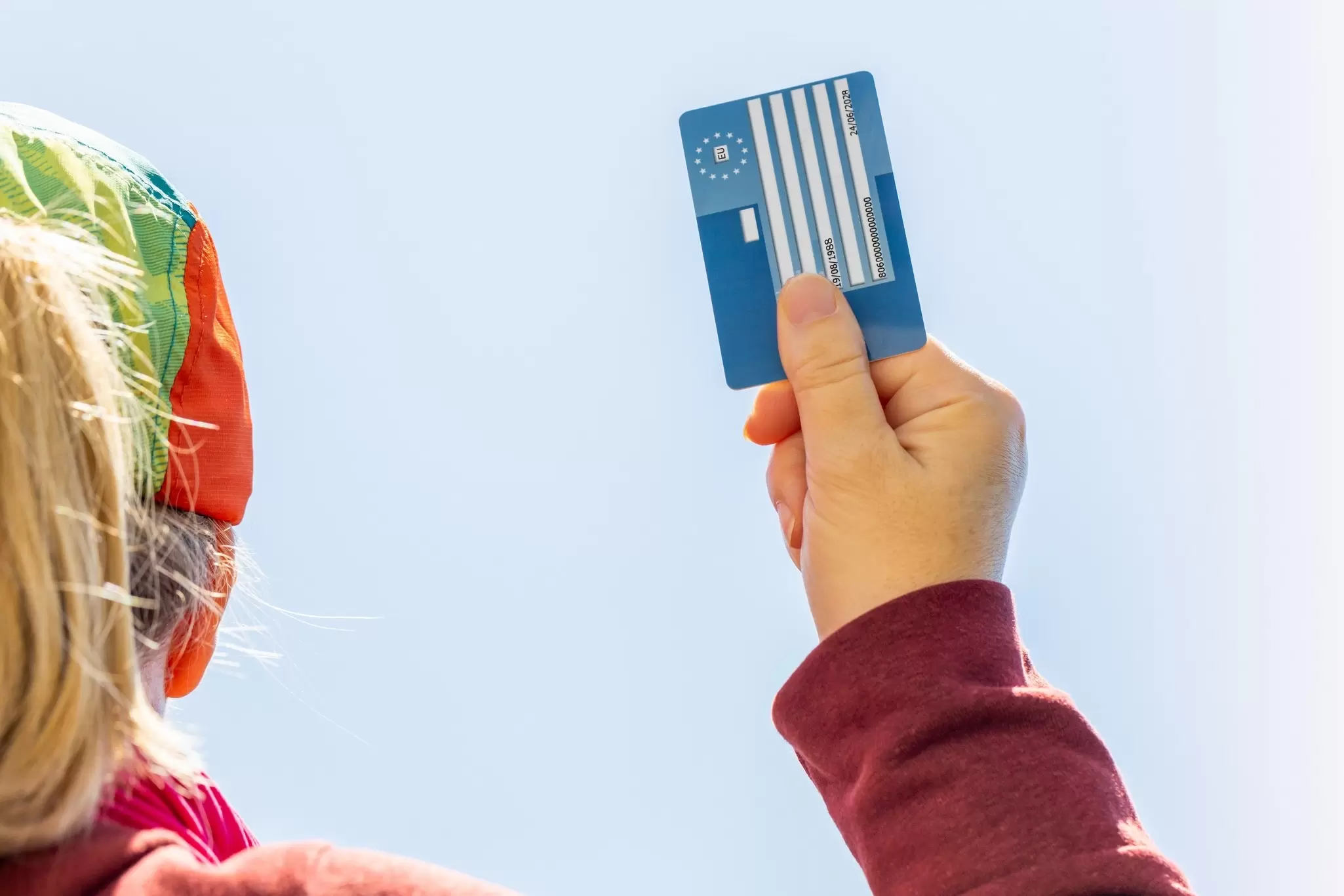 European Health Insurance Card in hand for women. Andrzej Rostek / Shutterstock