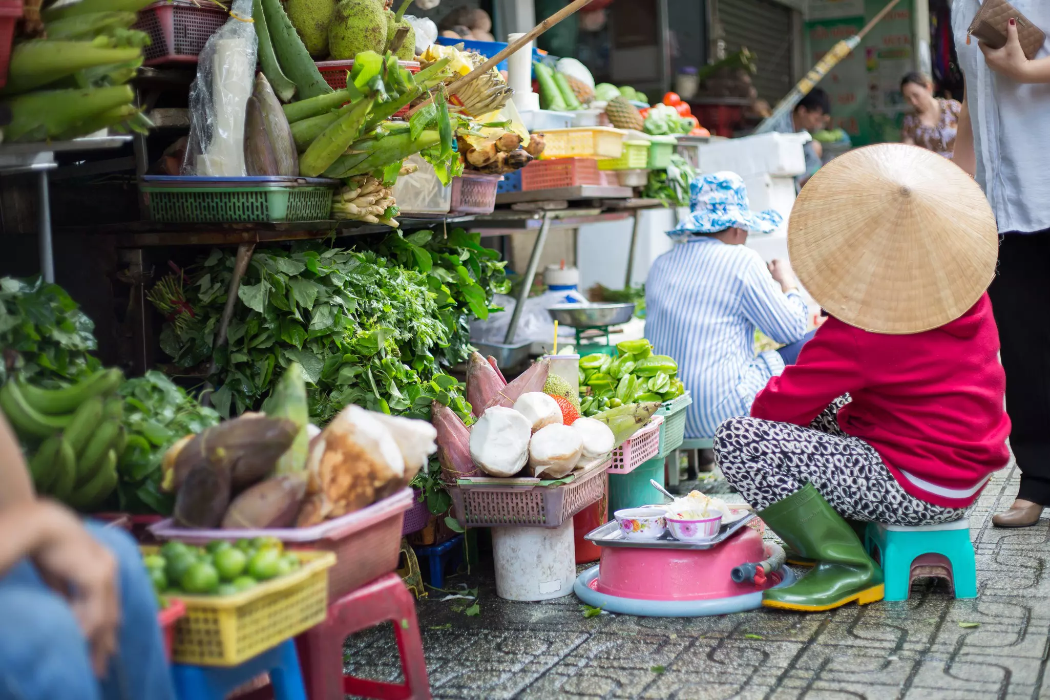 A vendor selling fruit and vegetables at Ben Thanh Market