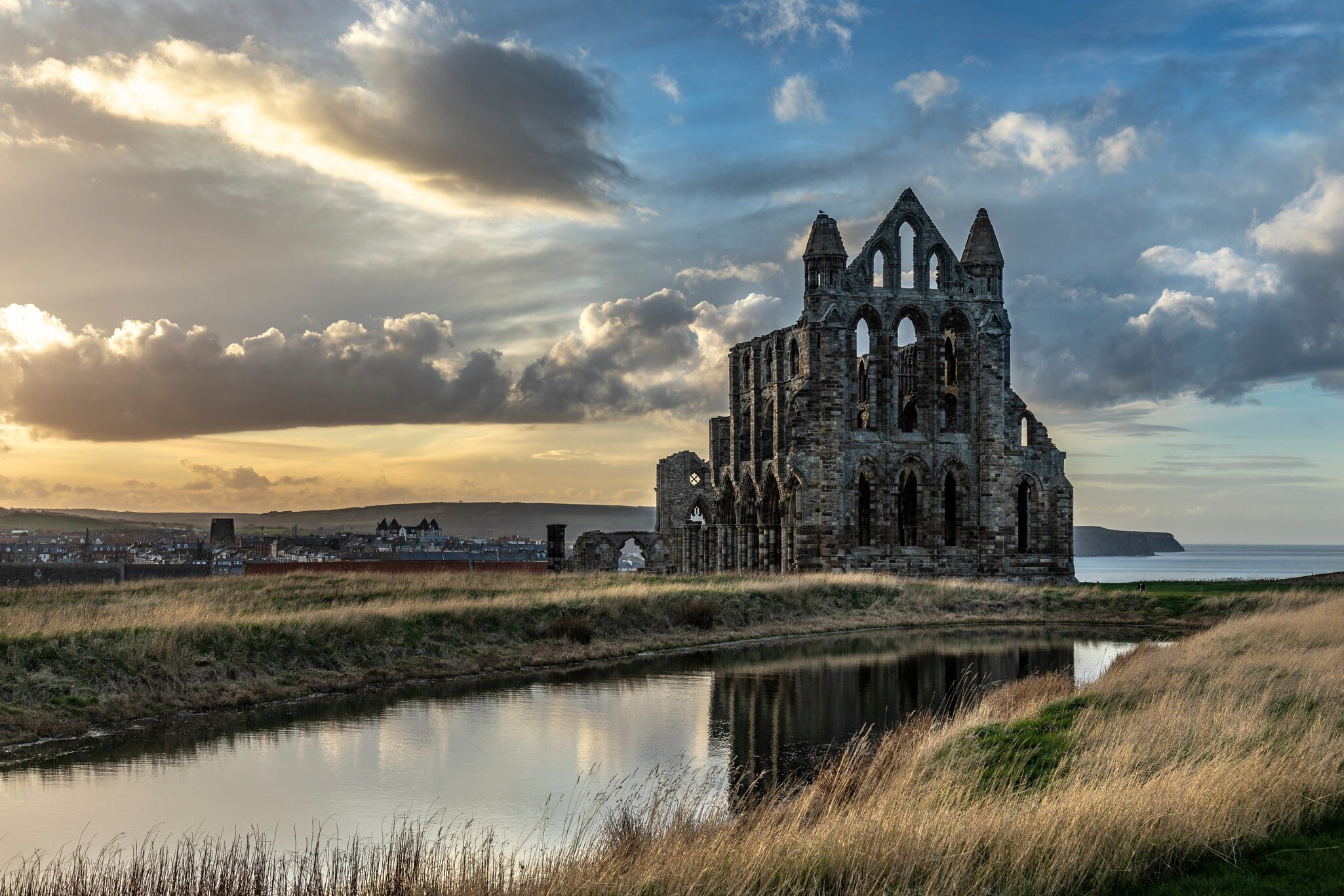 Exterior of Whitby Abbey during sunset.