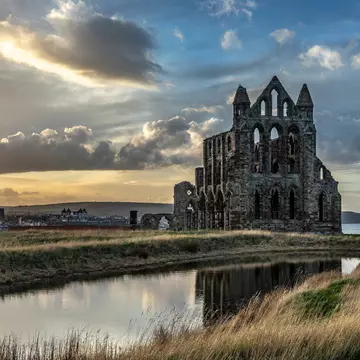 Exterior of Whitby Abbey during sunset.