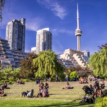 People sitting in the Toronto Music Garden, inspired by Bach's First Suite for Unaccompanied Cello.