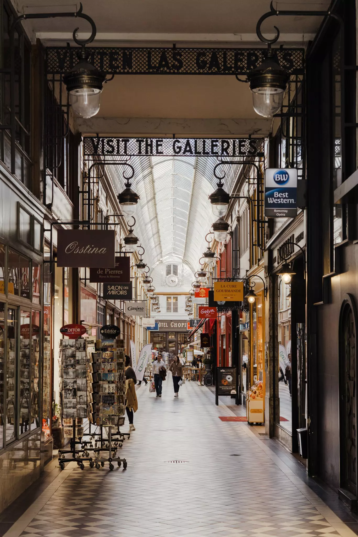 People wander through a covered shopping arcade.