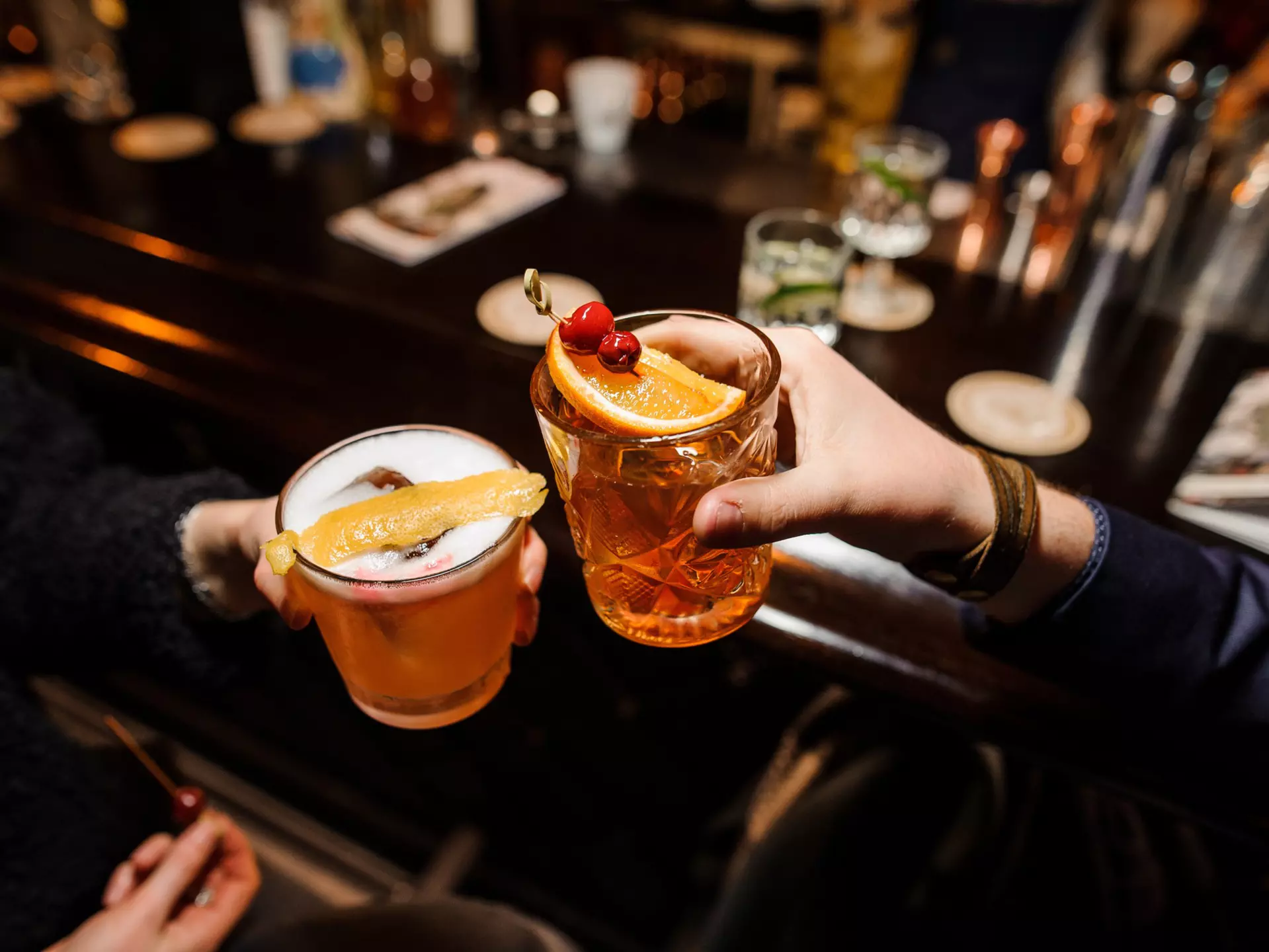A man and a woman cheersing glasses at a bar counter - a sour mix and Negroni with orange and cherry.
1009098397
alcohol, alcoholic, alcoholic drink, aperitif, are, background, bar, beverage, bitter, campari, cherry, clinking, close up, cocktail, cocktail glass, cold, colorful, cool, counter, drink, fashioned, freshness, gin, glasses, ice, lifestyle, liquid, liquor, man, mix, mixing, mixologist, negroni, orange, party, pouring, preparation, refreshment, restaurant, rum, sitting, sour, sparkling, stirring, woman